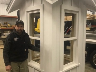 James Schettek, grandson of the barn builder, stands next to the completed, but yet to be installed, cupola.